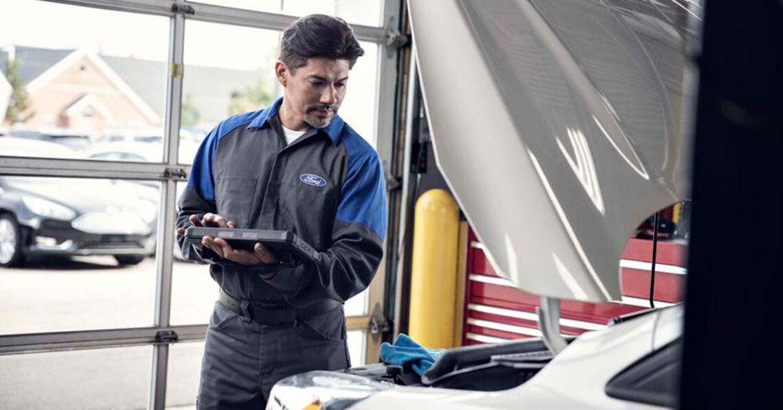 Technician performing Ford engine service