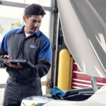 Technician performing Ford engine service