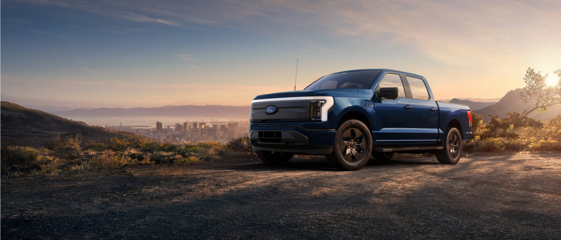 A Ford EV truck parked atop a hill