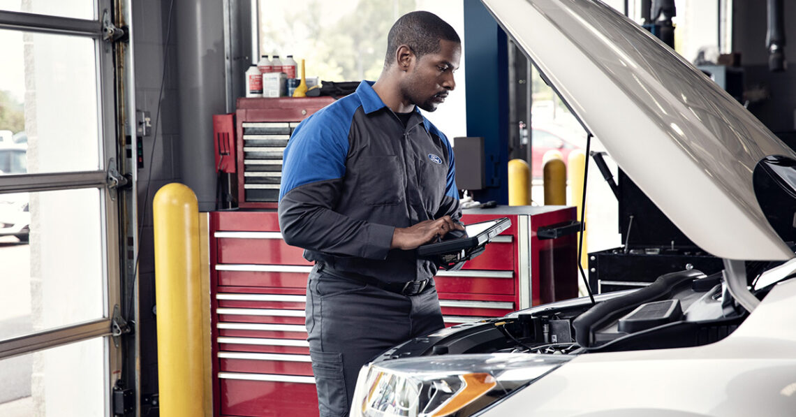 Ford service technician working under the hood