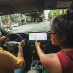 2026 Ford Escape PHEV interior with a driver and passenger.