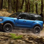 2026 Ford Bronco Sport driving on a forest road.